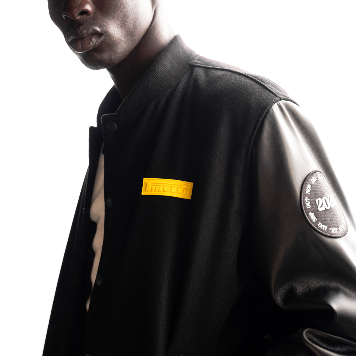 man wearing a black Pirelli canvas and leather bomber jacket
