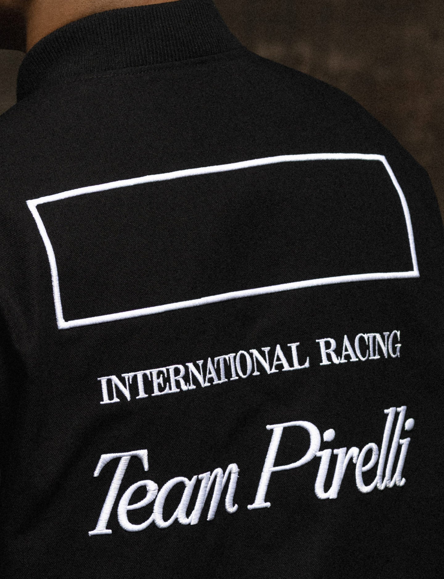Black jacket with 'International Racing Team Pirelli' text on the back