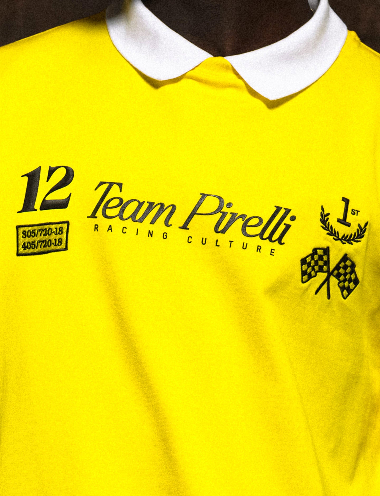 Yellow shirt with 'Team Pirelli Racing Culture' text and logos on a model.