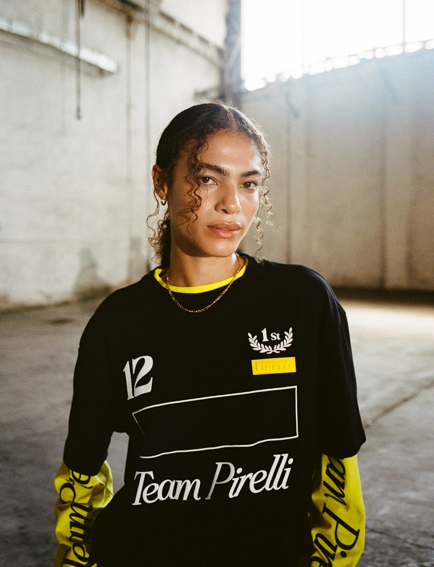 Person wearing a black and yellow 'Team Pirelli' shirt in an indoor setting