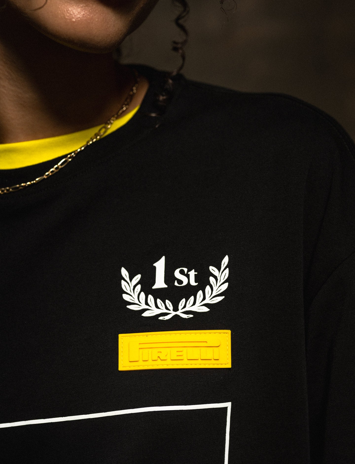 Black shirt with '1st' and 'Pirelli' branding on a dark background