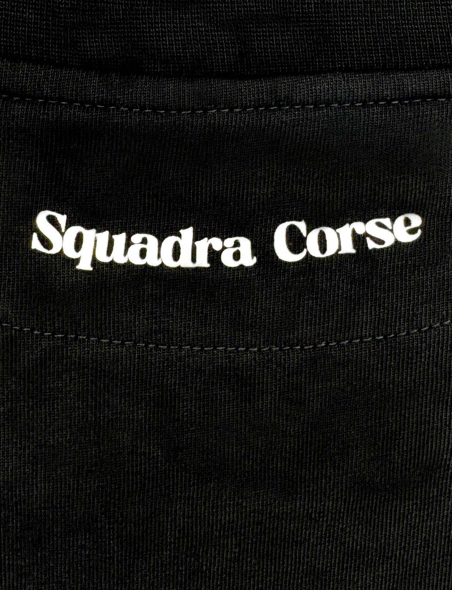 Close-up of 'Squadra Corse' logo on a black background