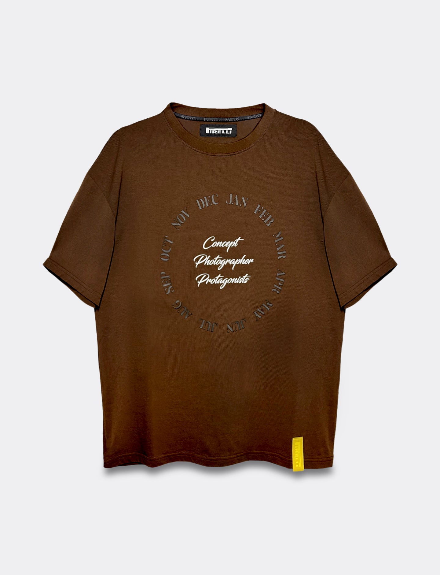 Brown Pirelli Calendar t-shirt with circular text design on a light gray background