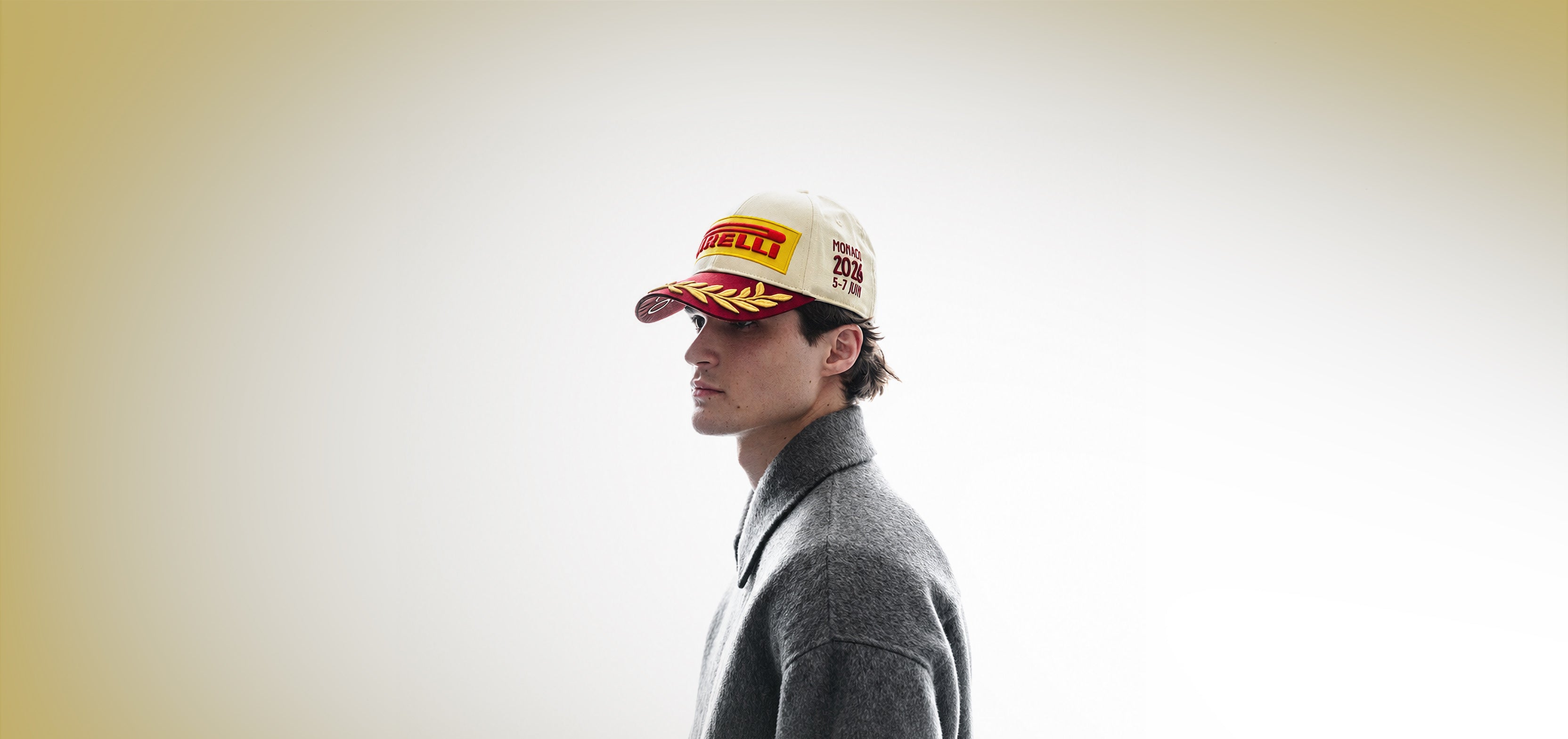 man wearing a Pirelli Podium Cap 2026 Monaco against a champagne and white background