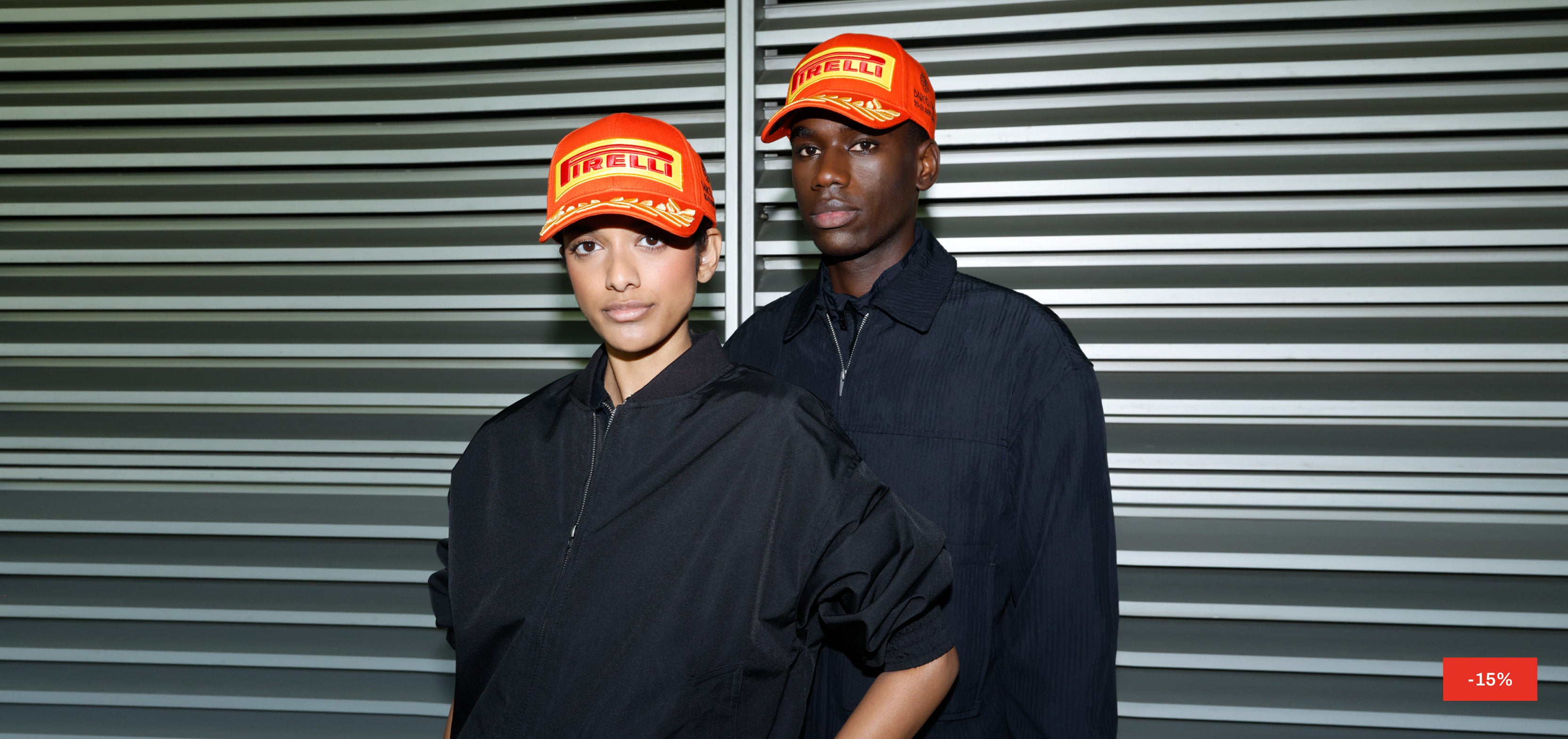man and woman in orange Pirelli caps