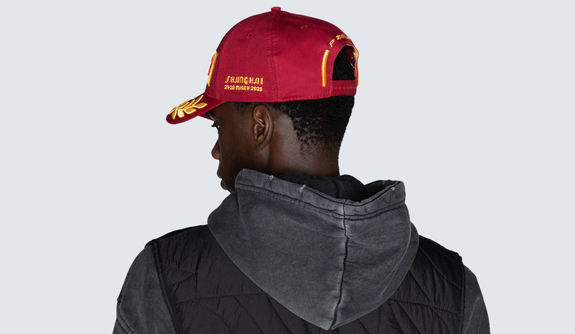 man with red Pirelli cap back view