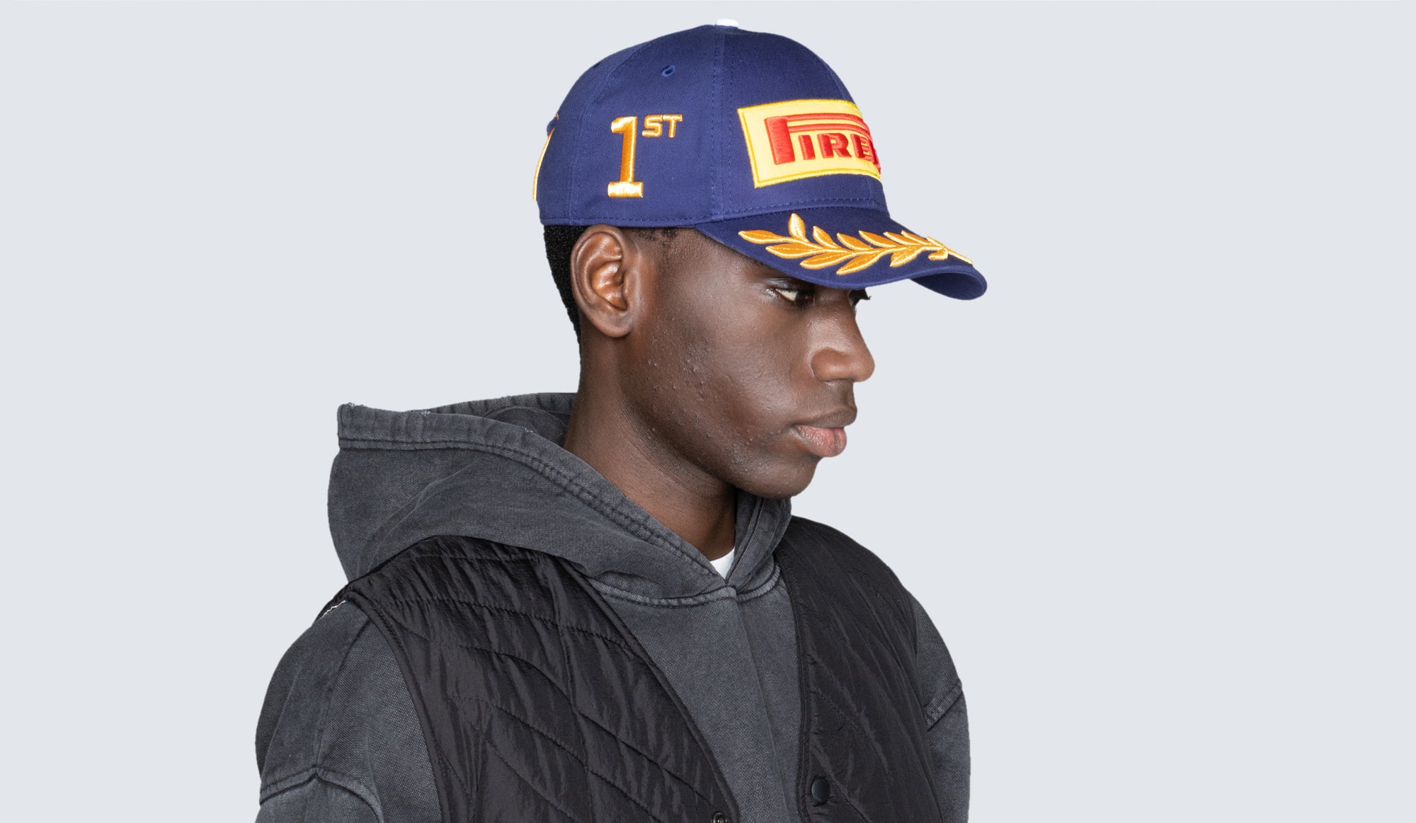 man in blue Pirelli cap side view