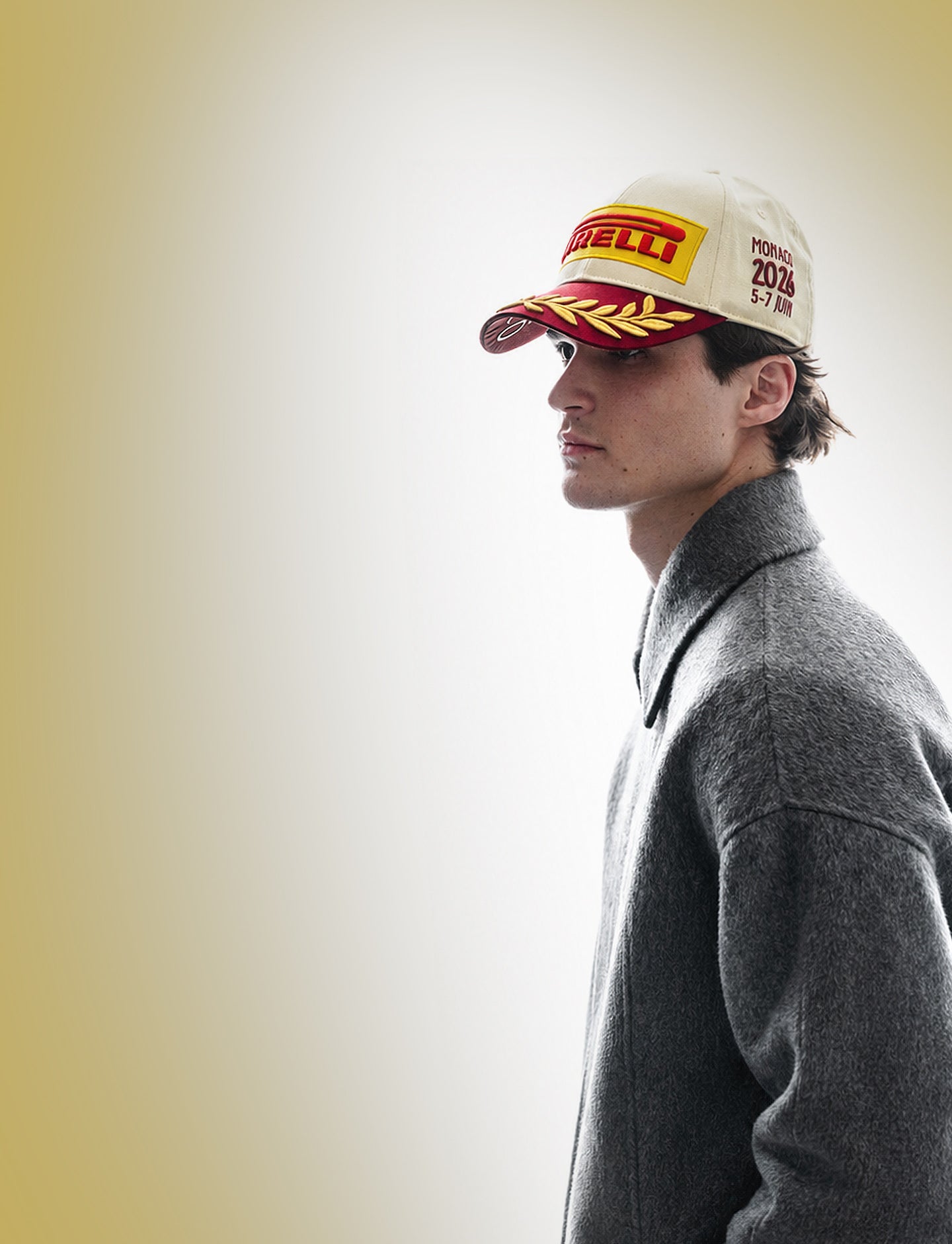 man wearing a Pirelli Podium Cap 2026 Monaco against a champagne and white background