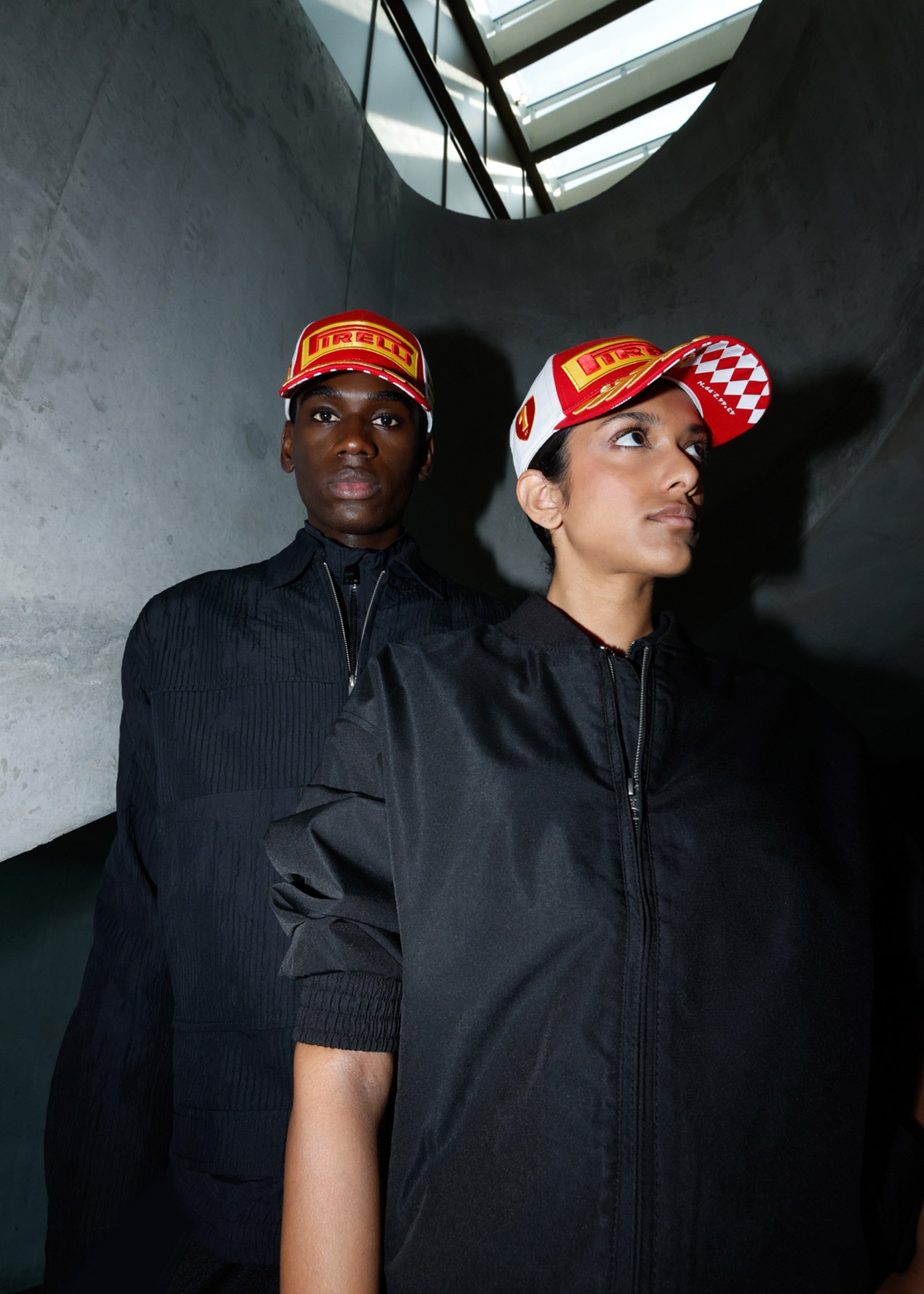 man and woman in red & white Pirelli Podium Caps
