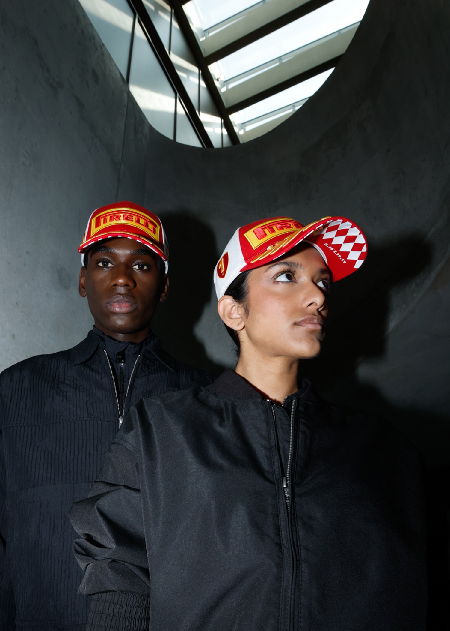 man and woman in red & white Pirelli Podium Cap