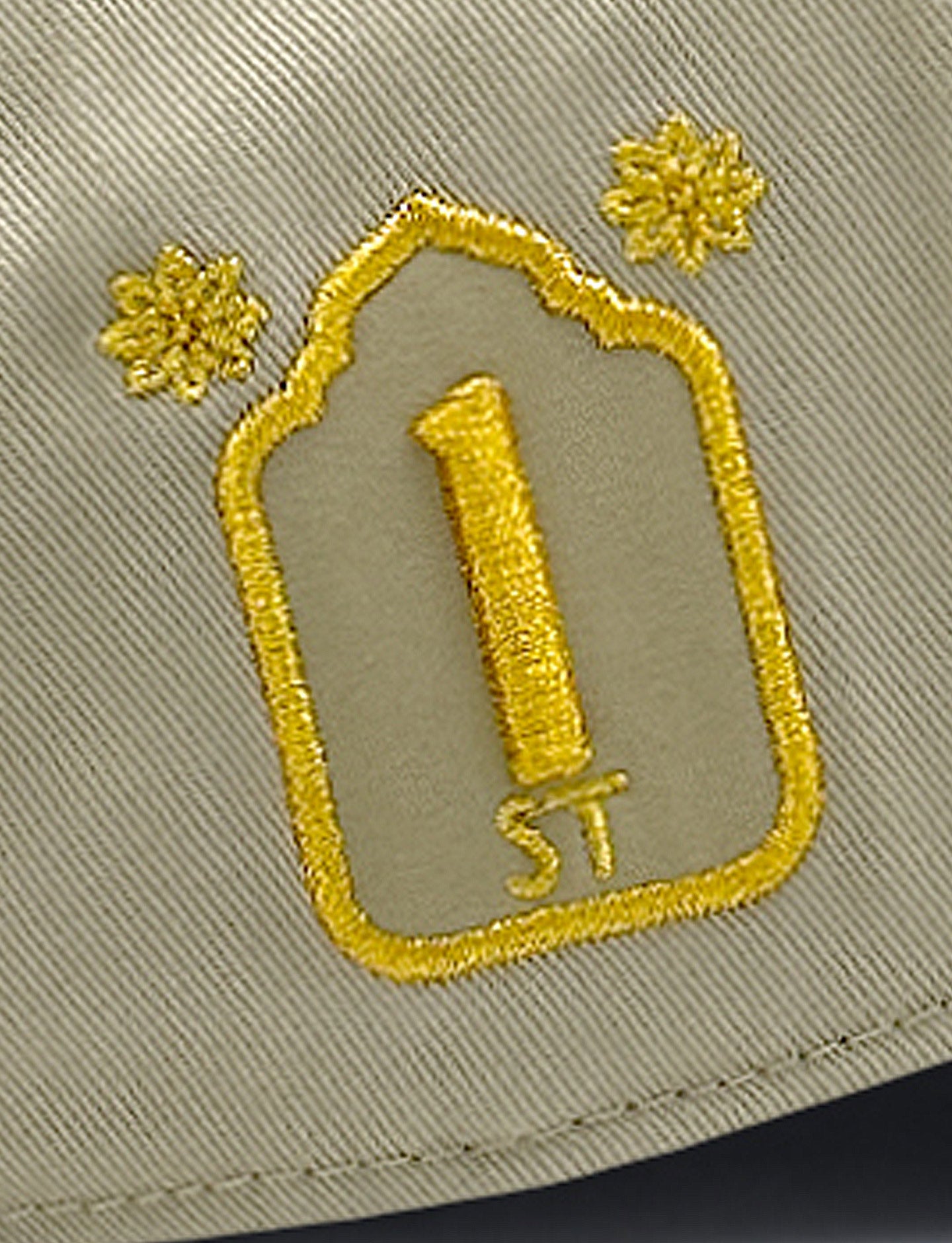 Embroidered number '1' on a beige background