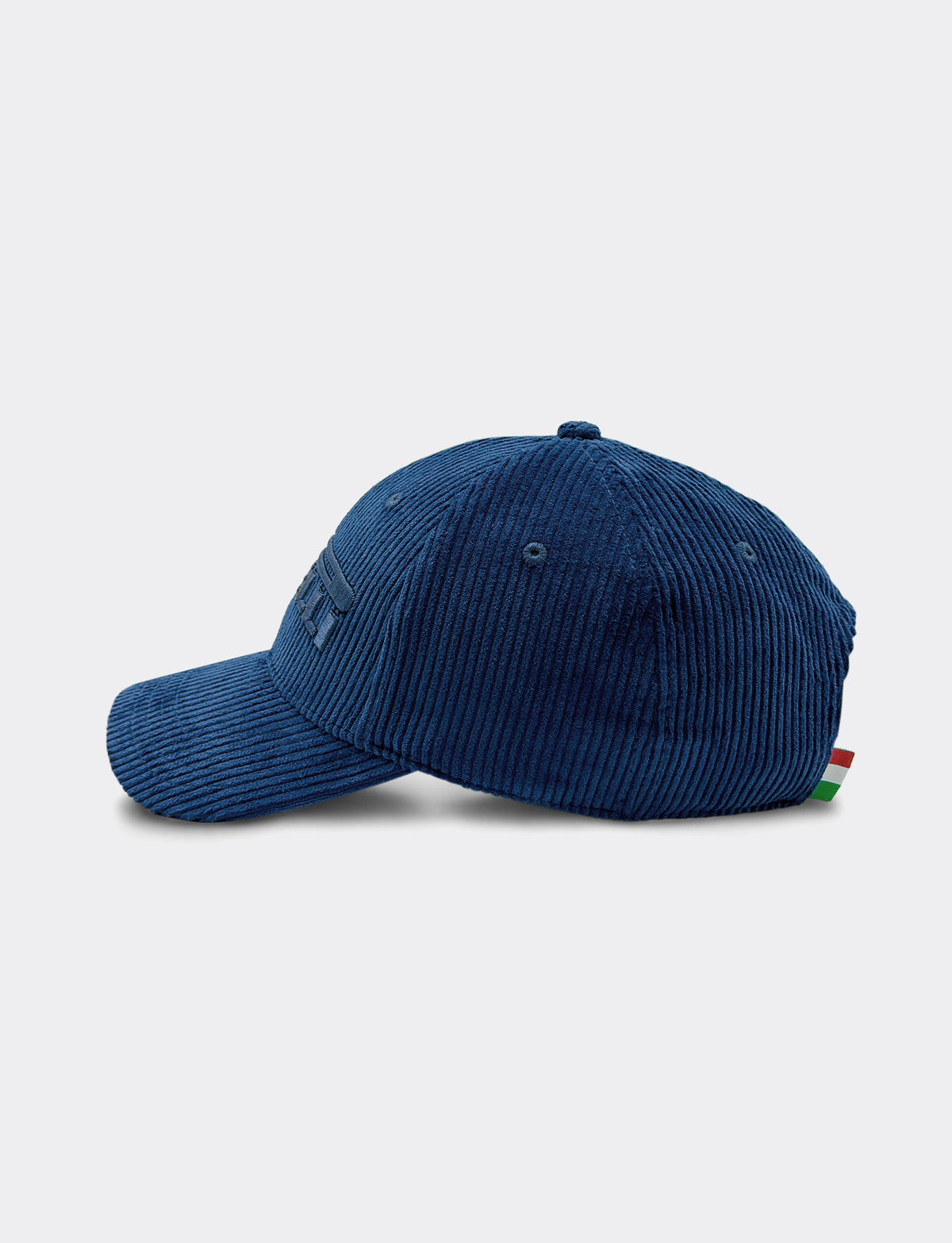 A dark blue Pirelli corduroy baseball cap shown from a side profile view with a small Italian flag on the back, against a light gray background.
