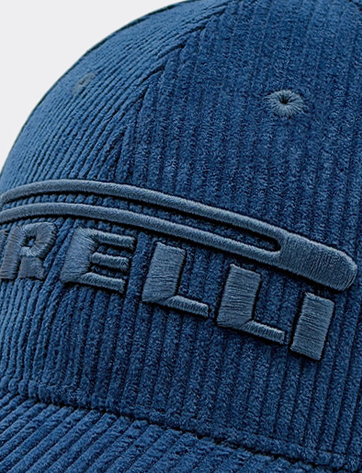 closeup of a blue Pirelli corduroy cap with "Pirelli" embroidered on the front