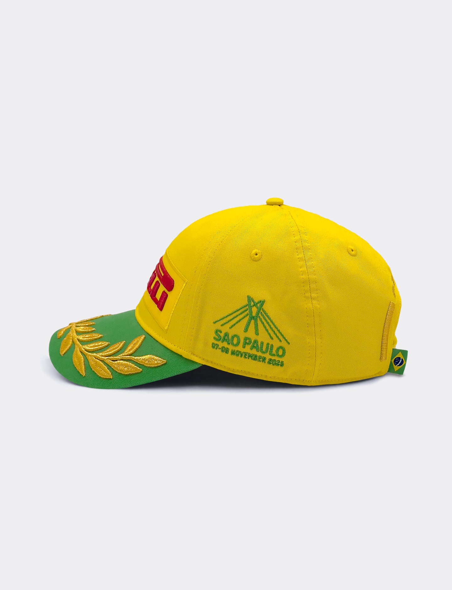 Yellow and green cap with Pirelli branding on a white background