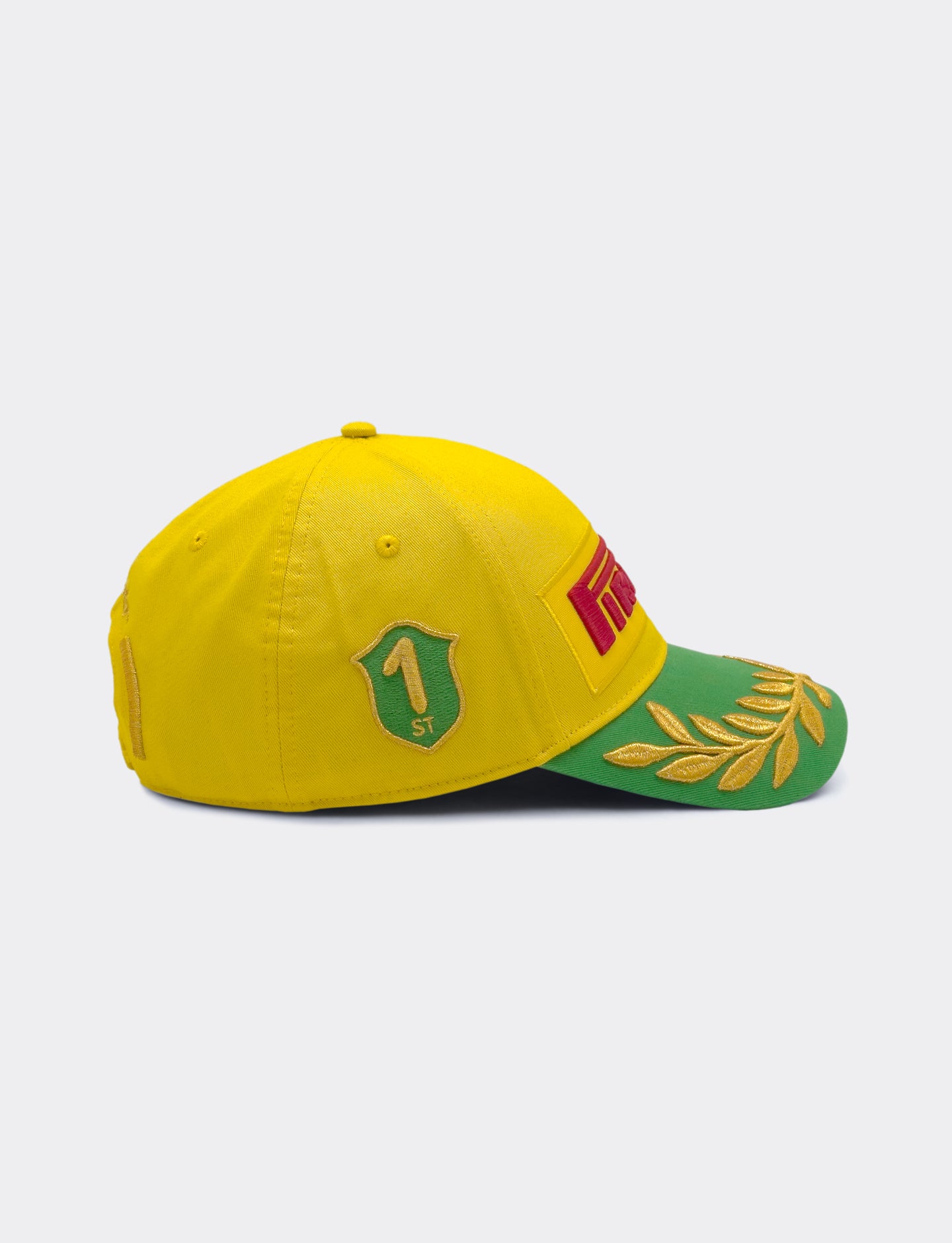 Yellow and green cap with Pirelli logo on a white background