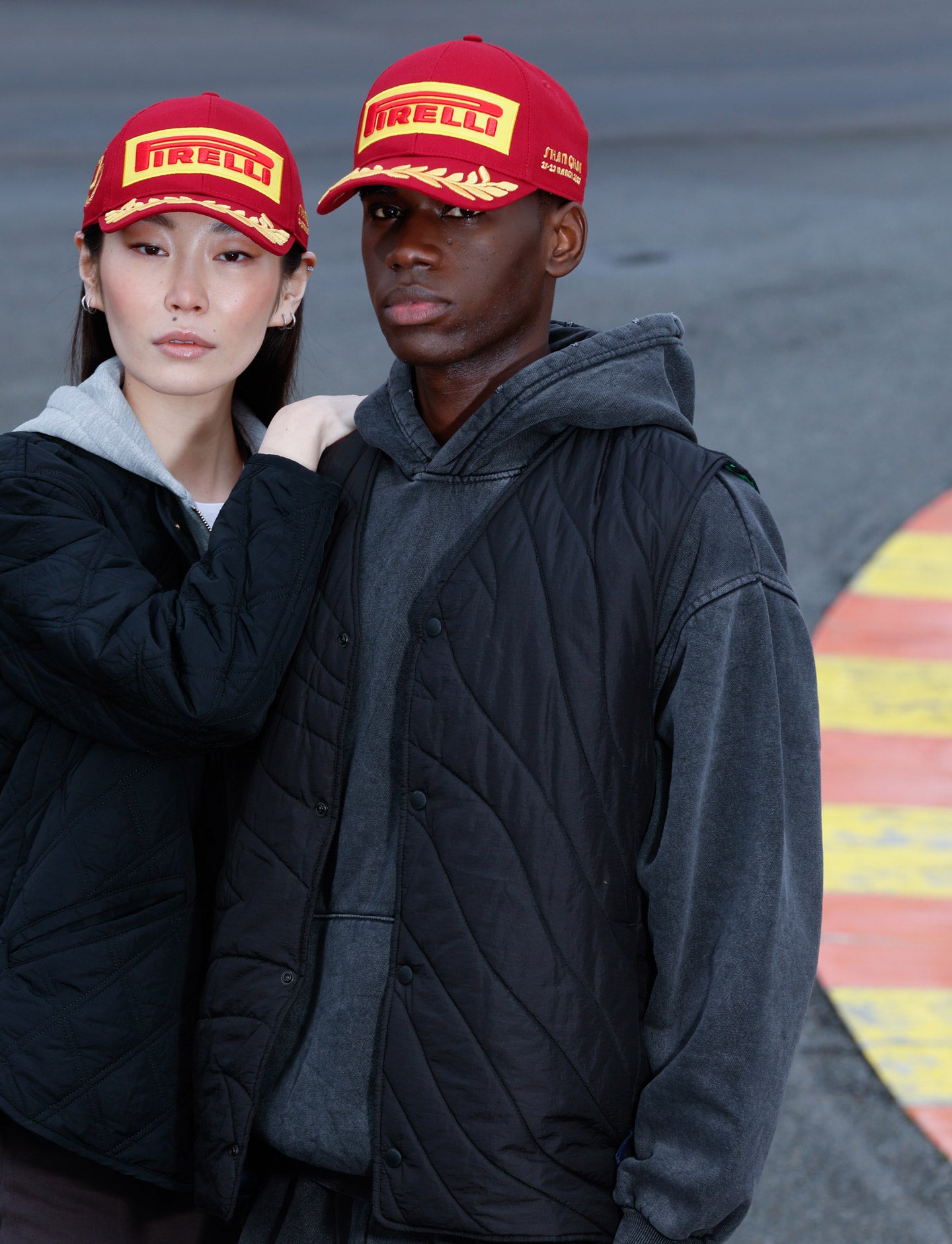 man and woman red caps at racetrack