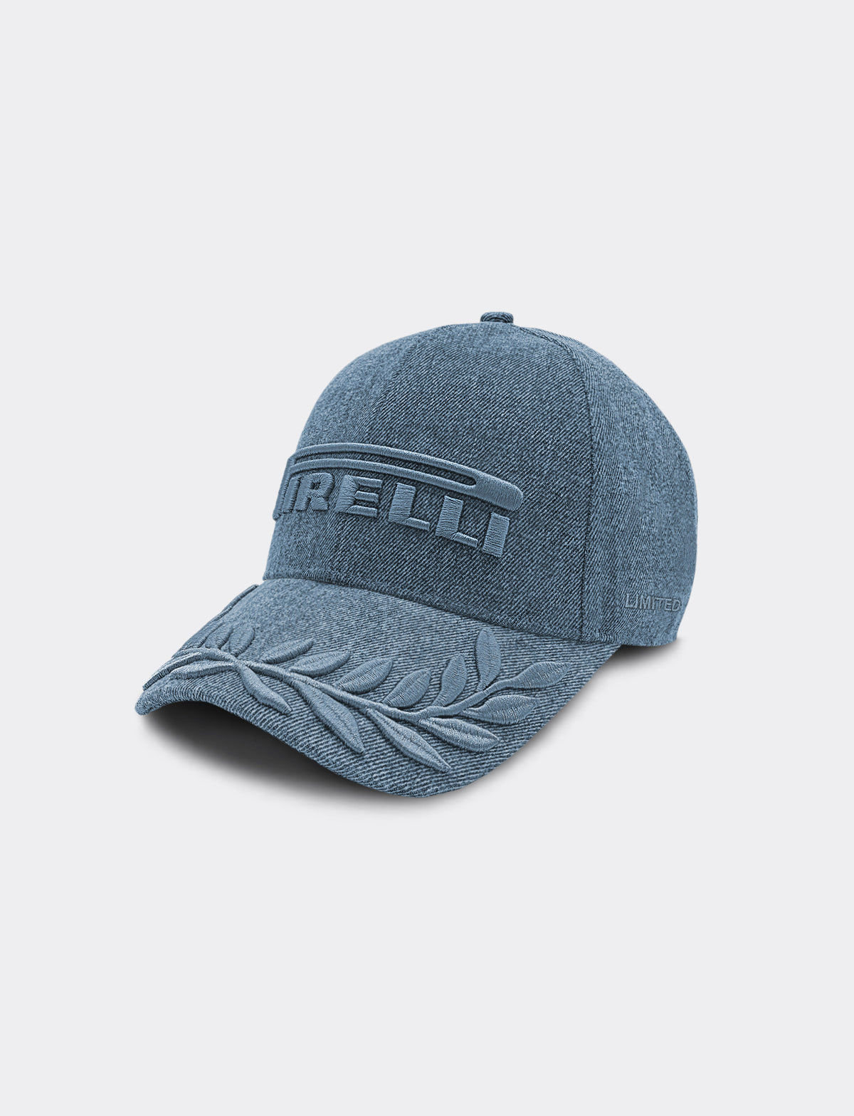 A blue denim Pirelli baseball cap featuring an embossed Pirelli logo on the front and a laurel motif on the brim, set against a light gray background.