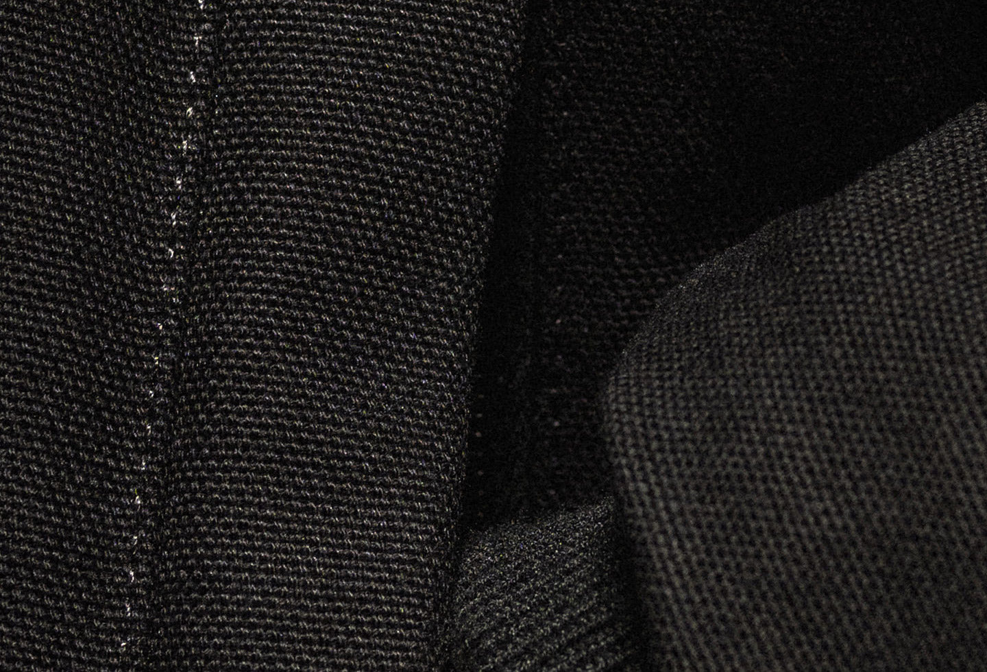 Close-up of black fabric texture with stitching details