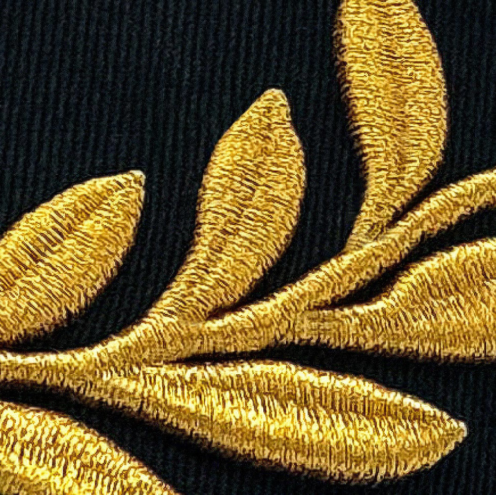 Closeup of gold laurel embroidery on Pirelli Podium Cap 2026