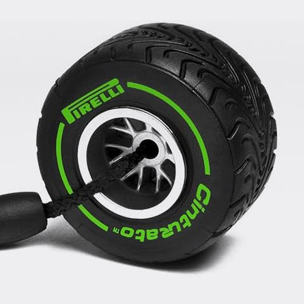 Black and green Pirelli tire-shaped object on a light gray background