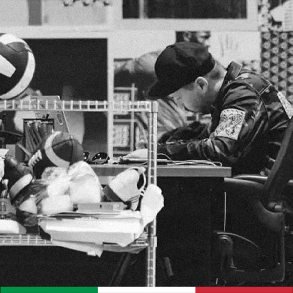 Person sitting at a desk working on a clothing design