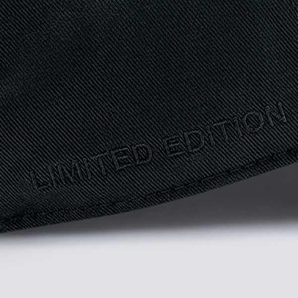 Close-up of a black cap with 'Limited Edition' text on a dark background