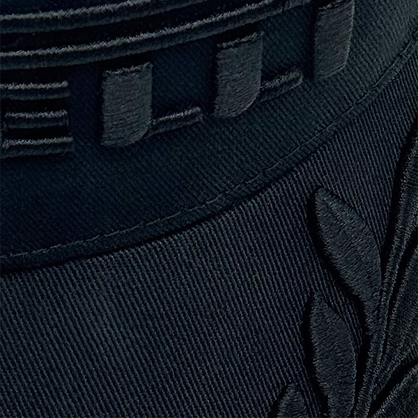 Close-up of a dark black cap with embroidery