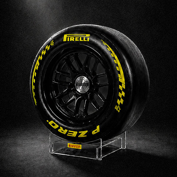 Pirelli tire on a stand against a black background
