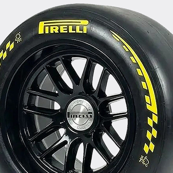 Close-up of a Pirelli tire with a black rim on a white background