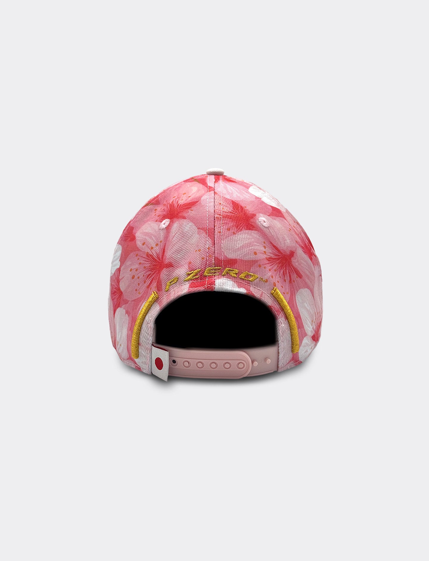 Pink floral-patterned Pirelli cap on a light gray background