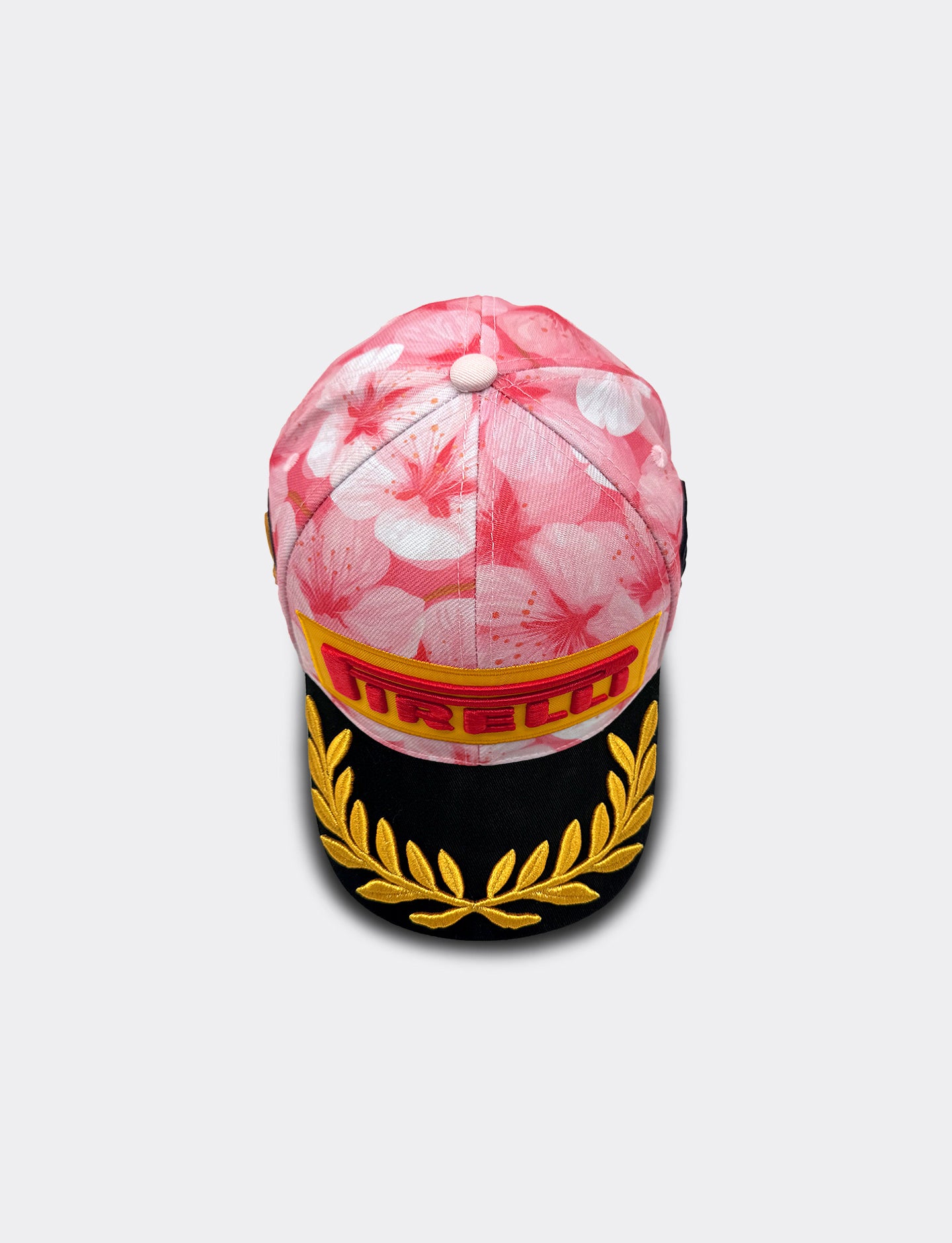 Cap with floral pattern and Pirelli logo on a white background