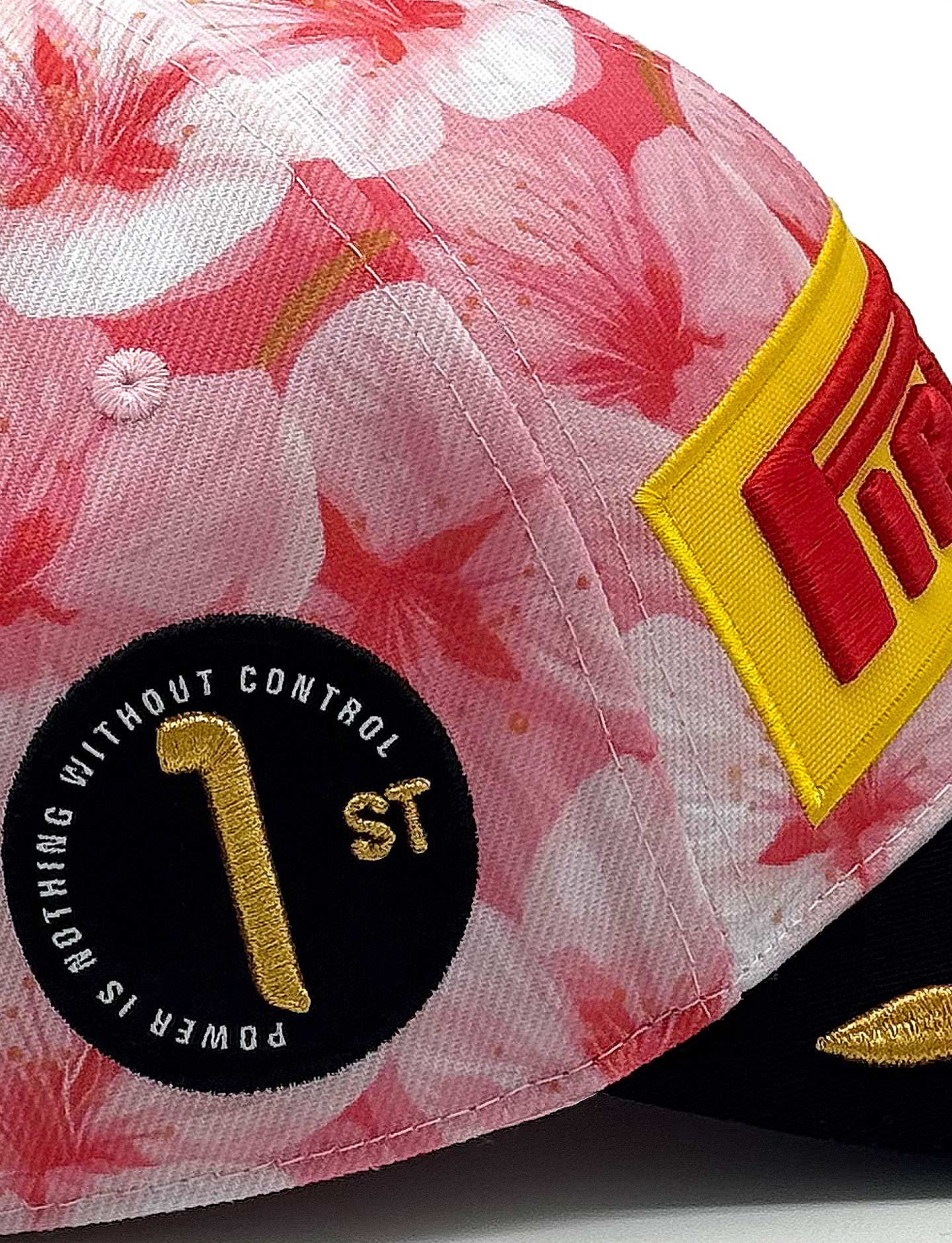 Pink floral cap with a Pirelli logo and text on a white background