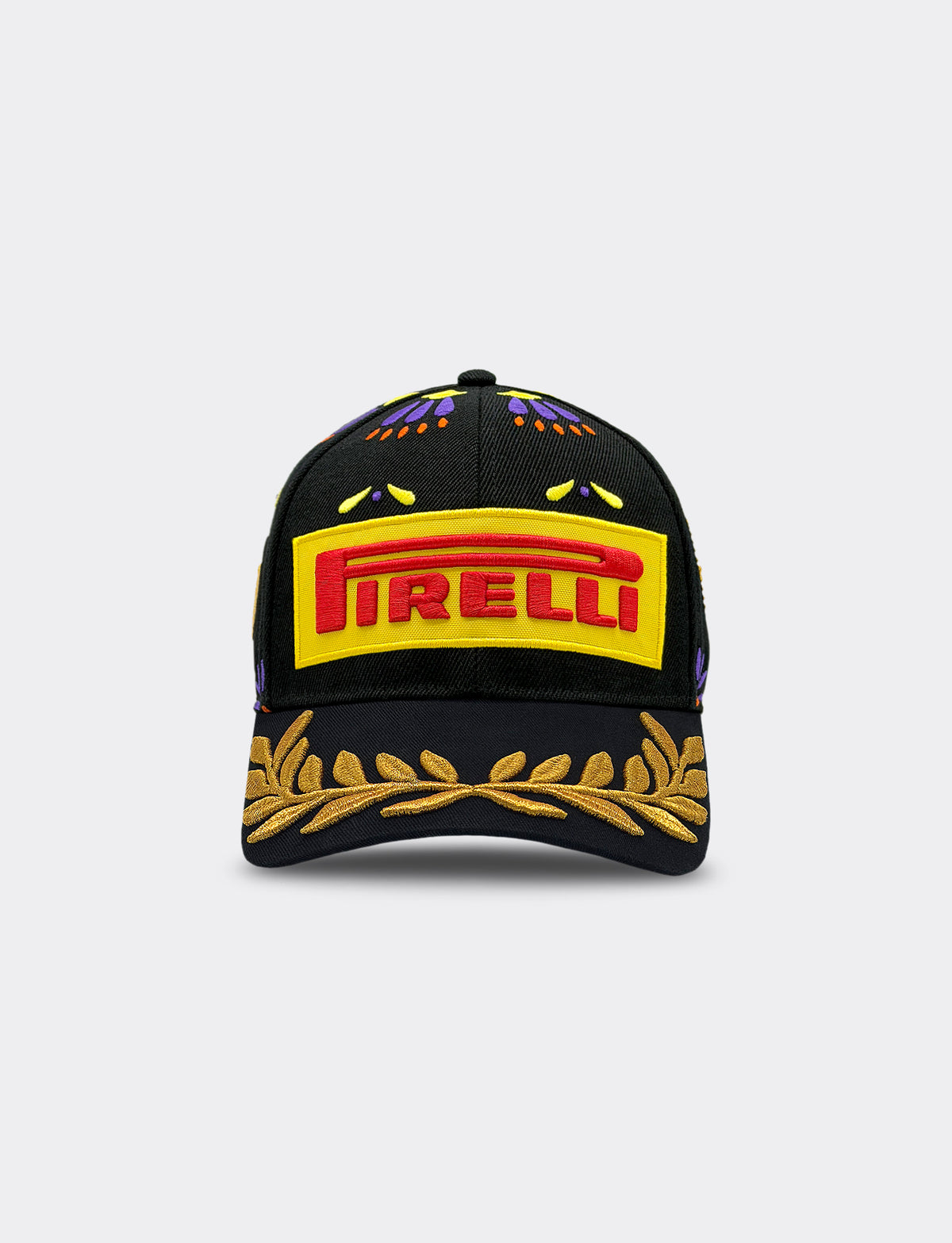 A black baseball cap featuring a prominent yellow and red Pirelli logo patch on the front, with gold embroidered laurel leaves on the brim and small multicolor embroidered details on the crown.