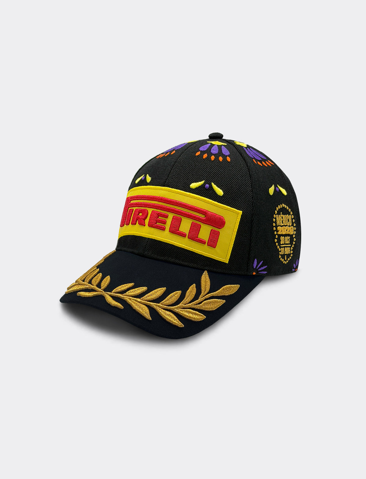 A black Pirelli Podium Cap 2026 Mexico baseball cap featuring a prominent yellow and red embroidered logo on the front, a gold laurel leaf embroidery on the brim, and multicolor geometric patterns on the crown.