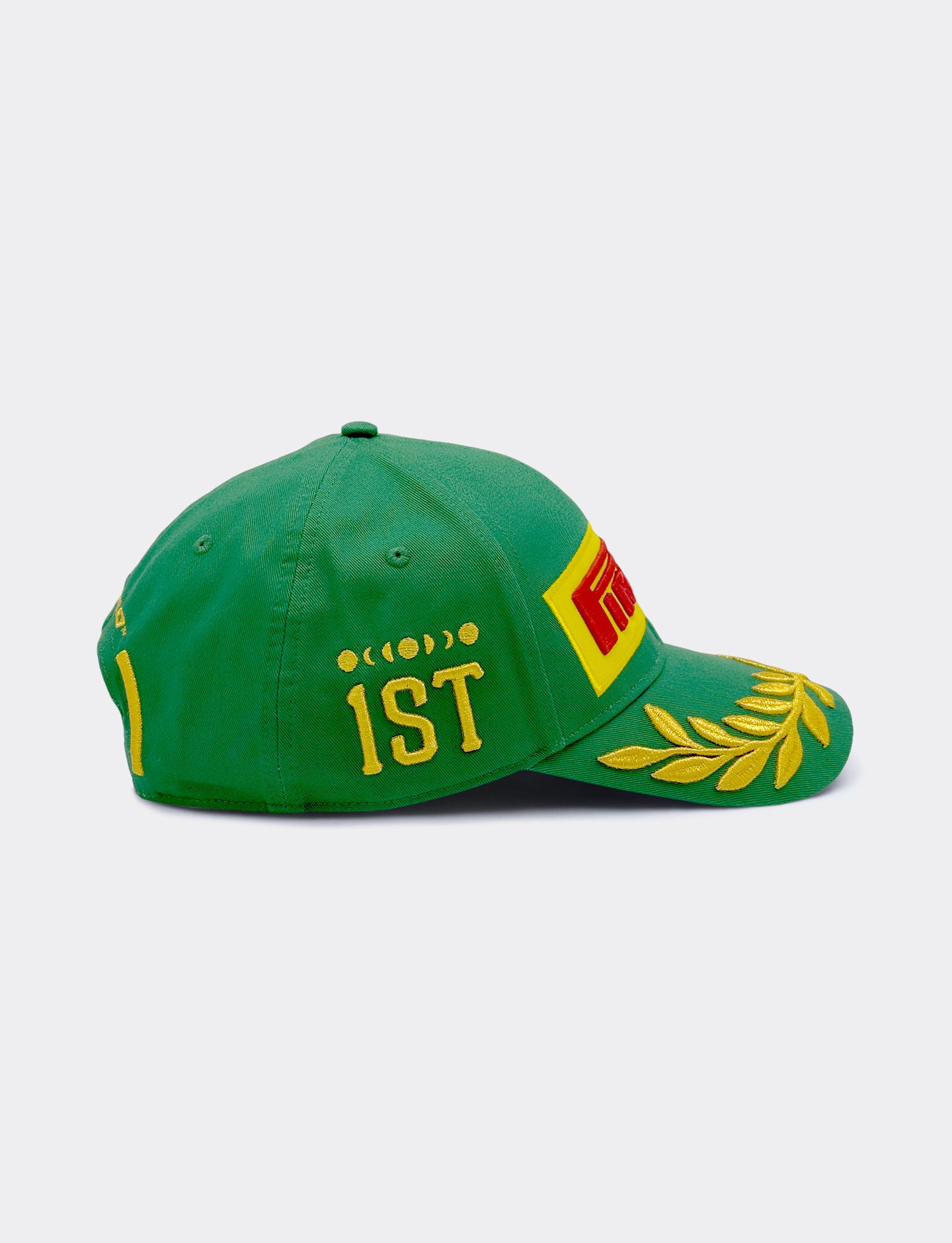 Green Pirelli cap with yellow and red details on a white background