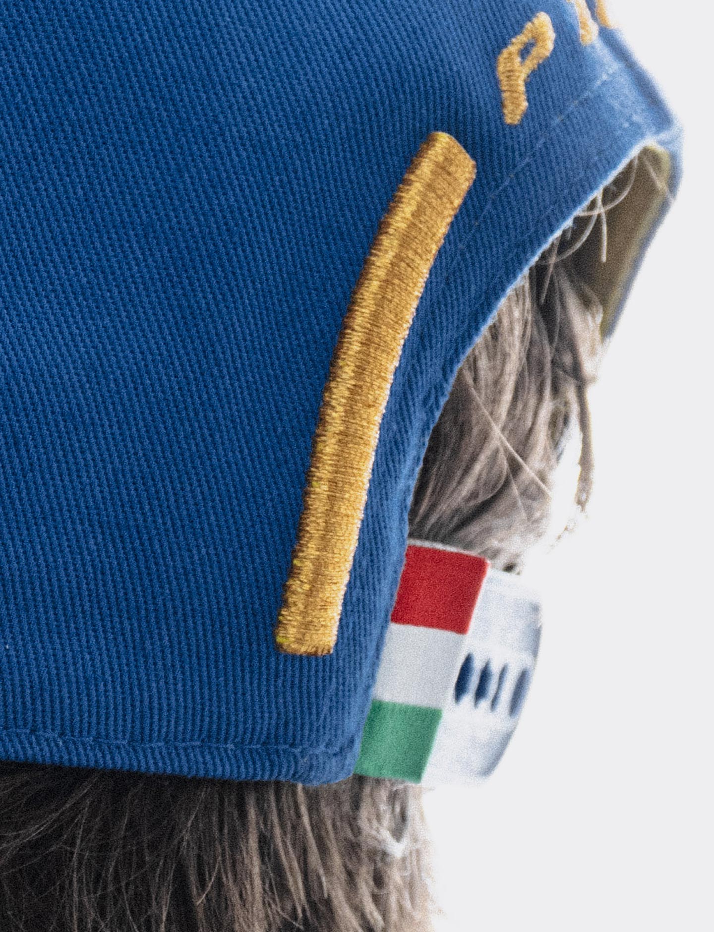 Close-up blue Pirelli Podium Cap 2026 Monza with a small Italian flag tag