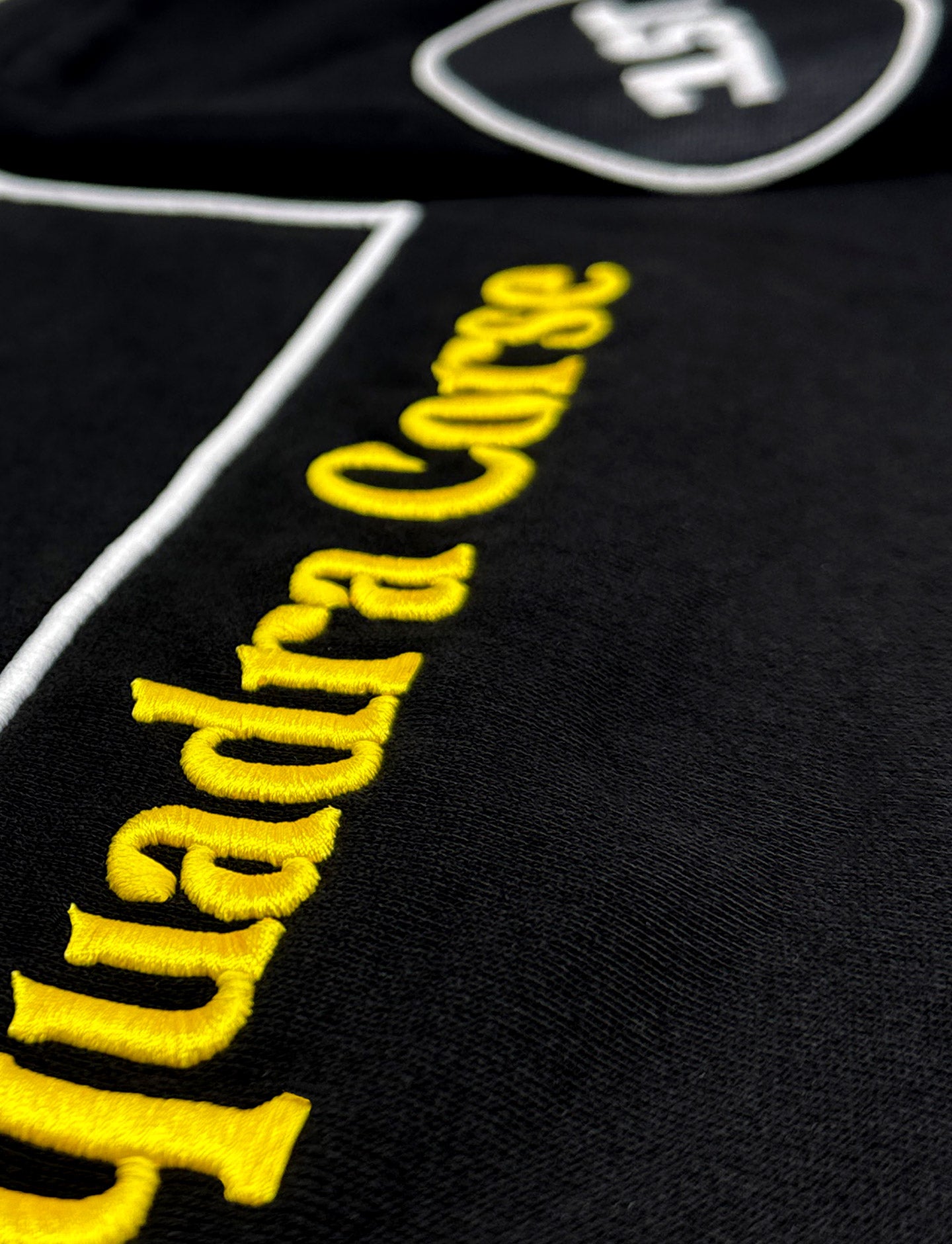 Black fabric with yellow 'Squadra-Corse' embroidery