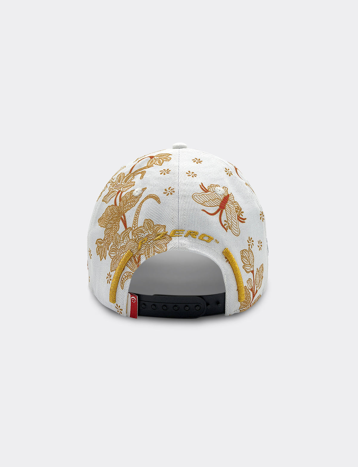 Back view of Pirelli Podium Cap 2026 Singapore featuring a white crown with orange/brown floral patterns, and gold "P ZERO" embroidery.