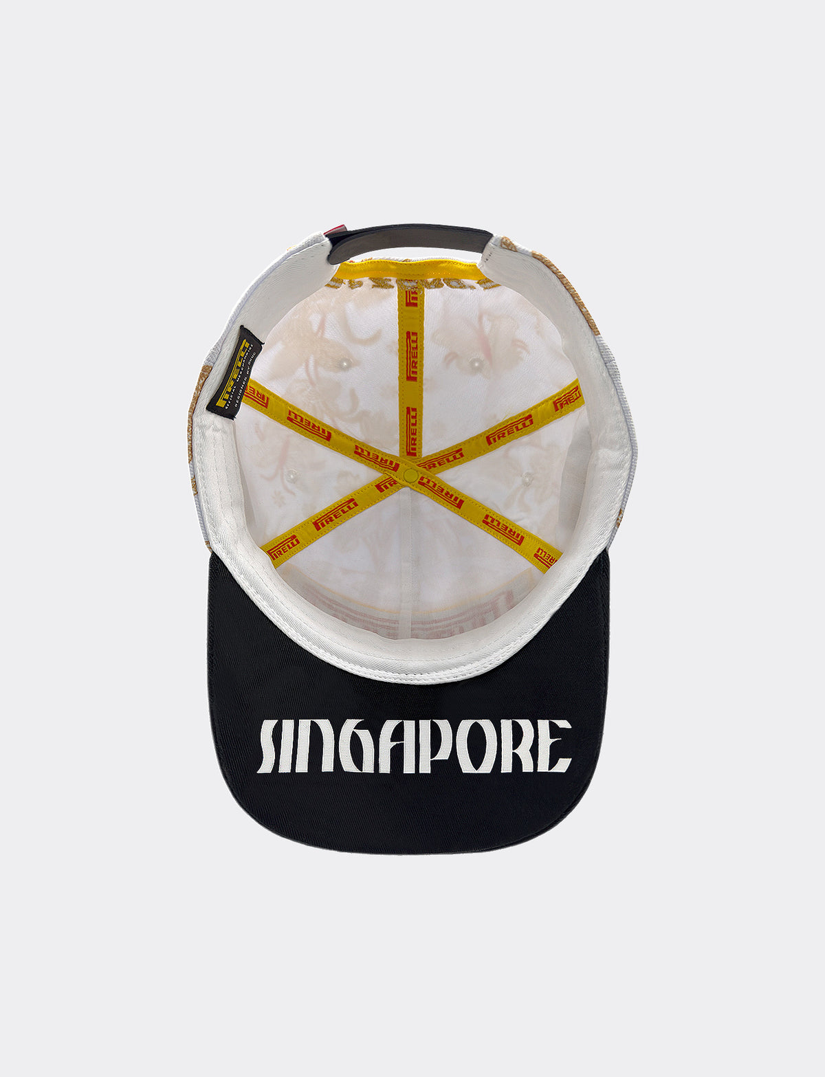 Under view of Pirelli Podium Cap 2026 Singapore, white cap with black brim with "Singapore" written in white on underbrim.