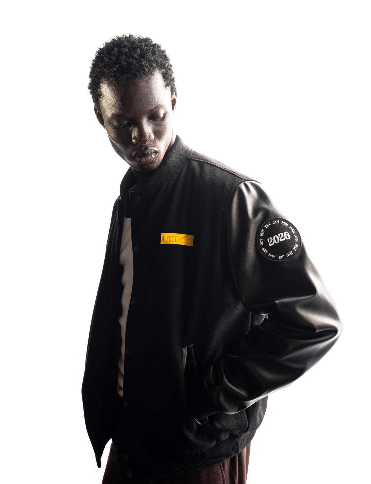 Person wearing a Pirelli Calendar jacket with visible branding on a white background