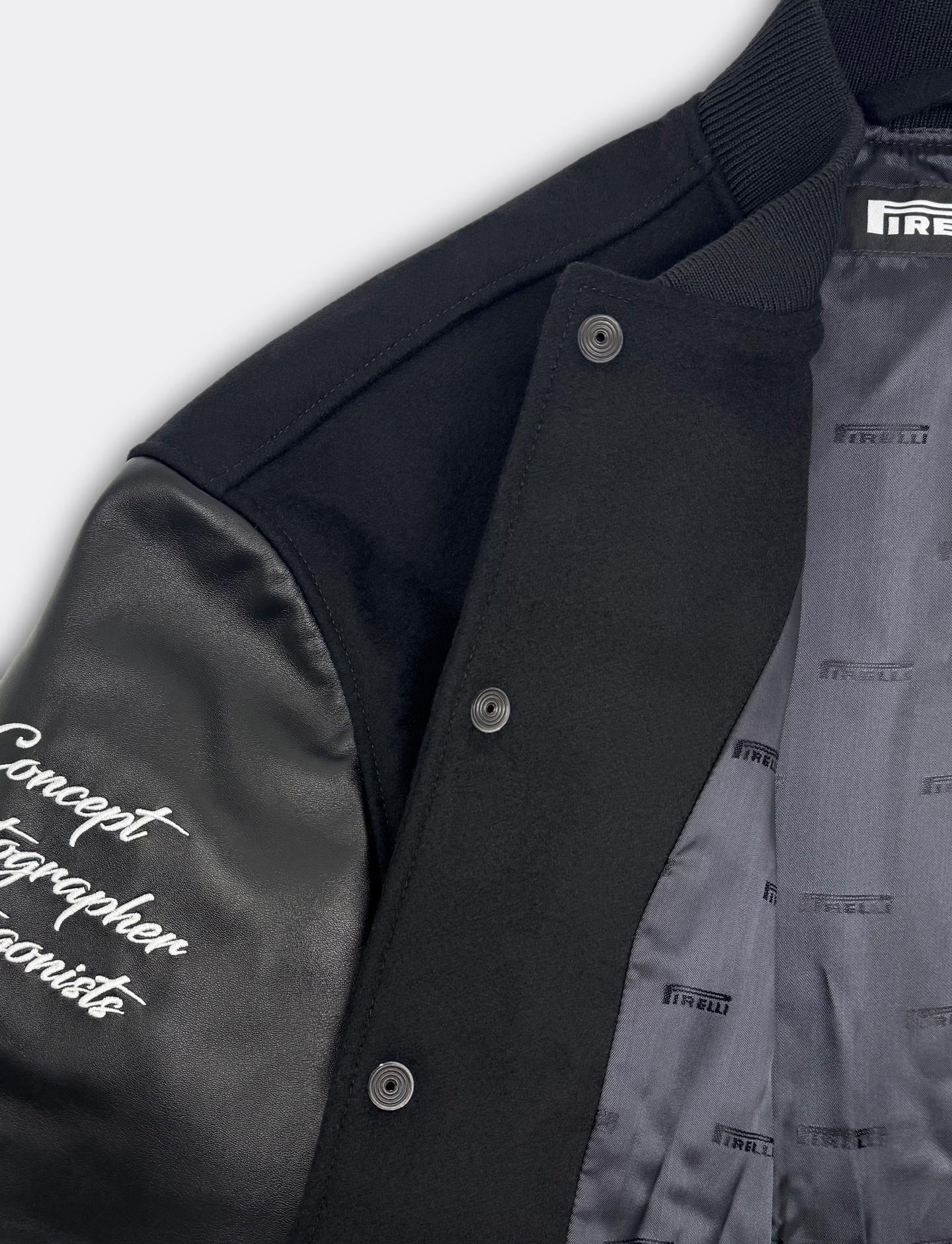 Close-up of a black jacket with Pirelli logo on lining