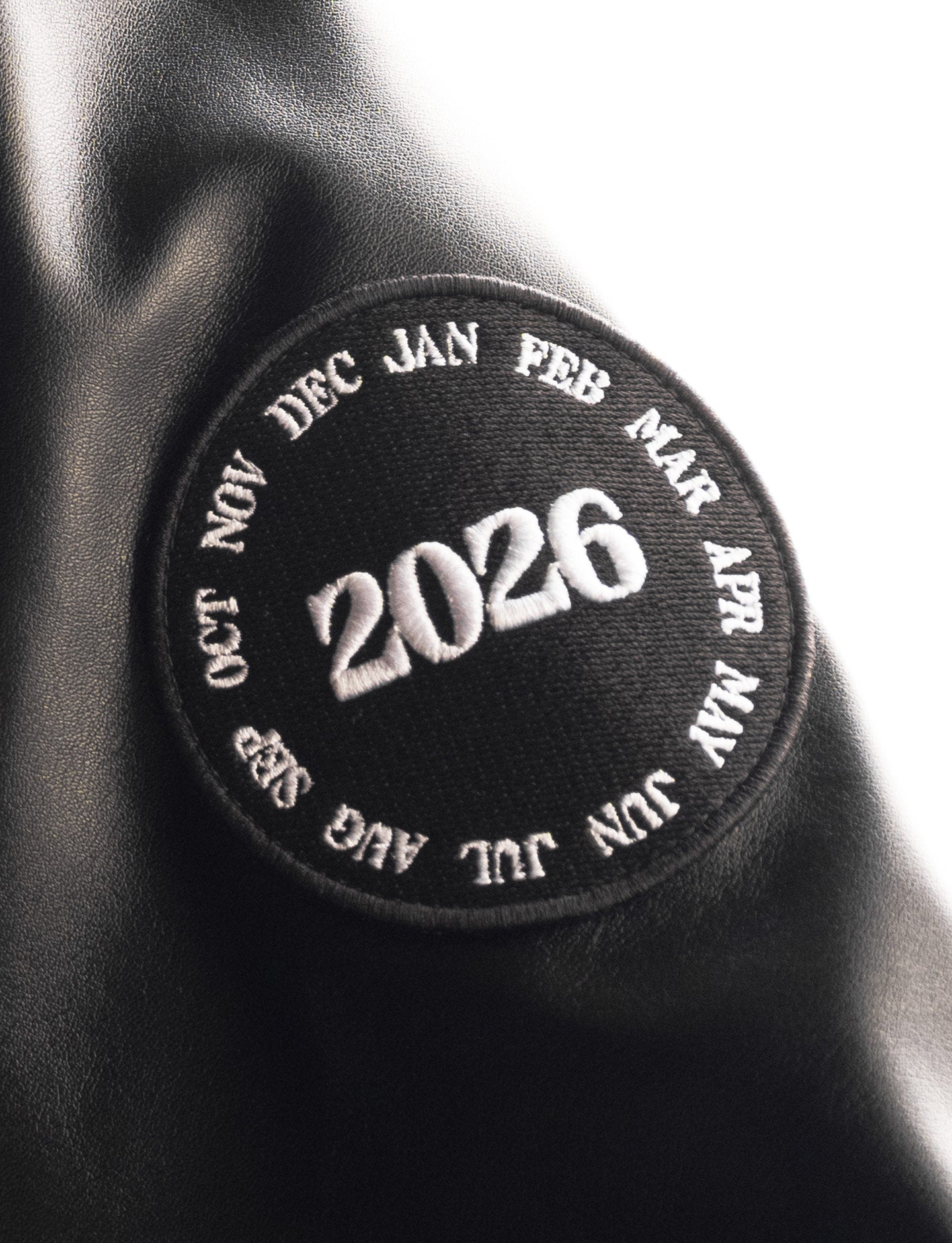 Black patch with '2026' and months printed on a black background