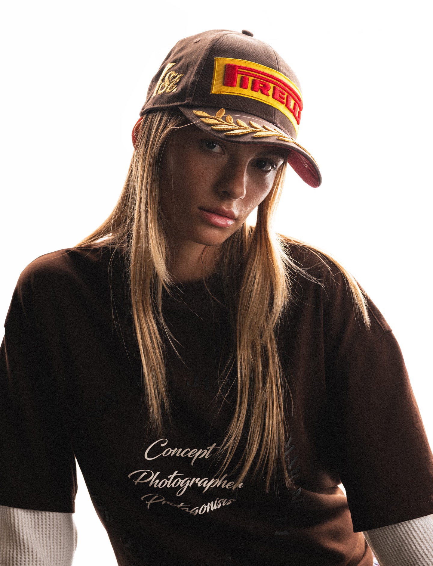 woman wearing brown Pirelli cap and tee