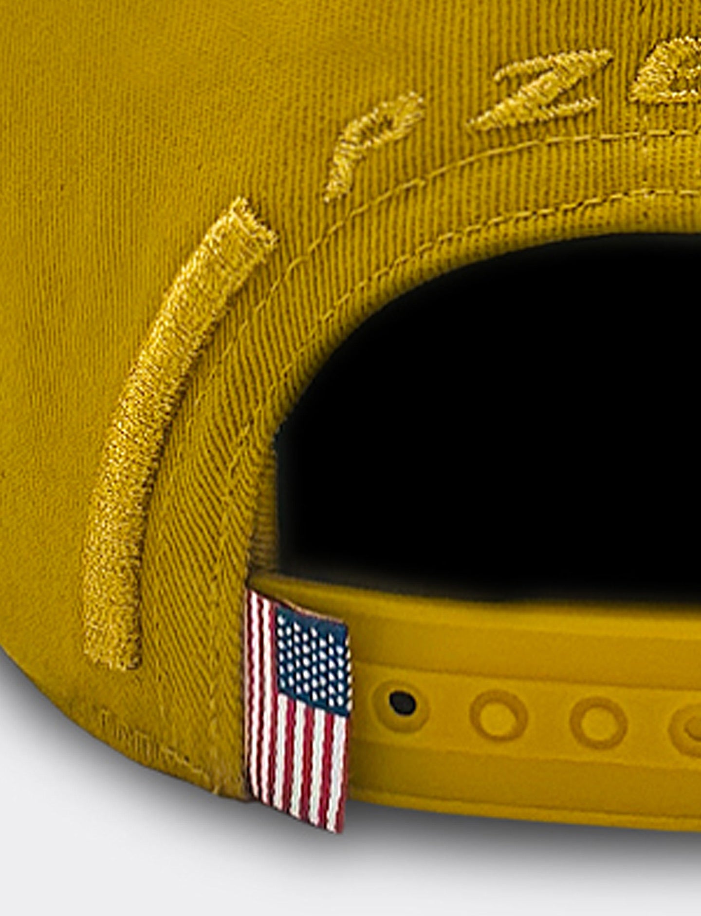 Gold cap with American flag emblem on a white background