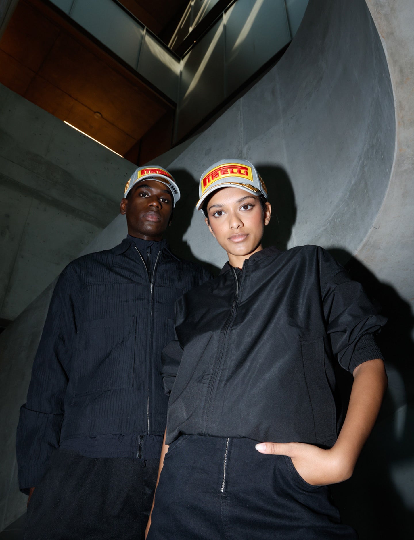 two people wearing silver Pirelli podium caps