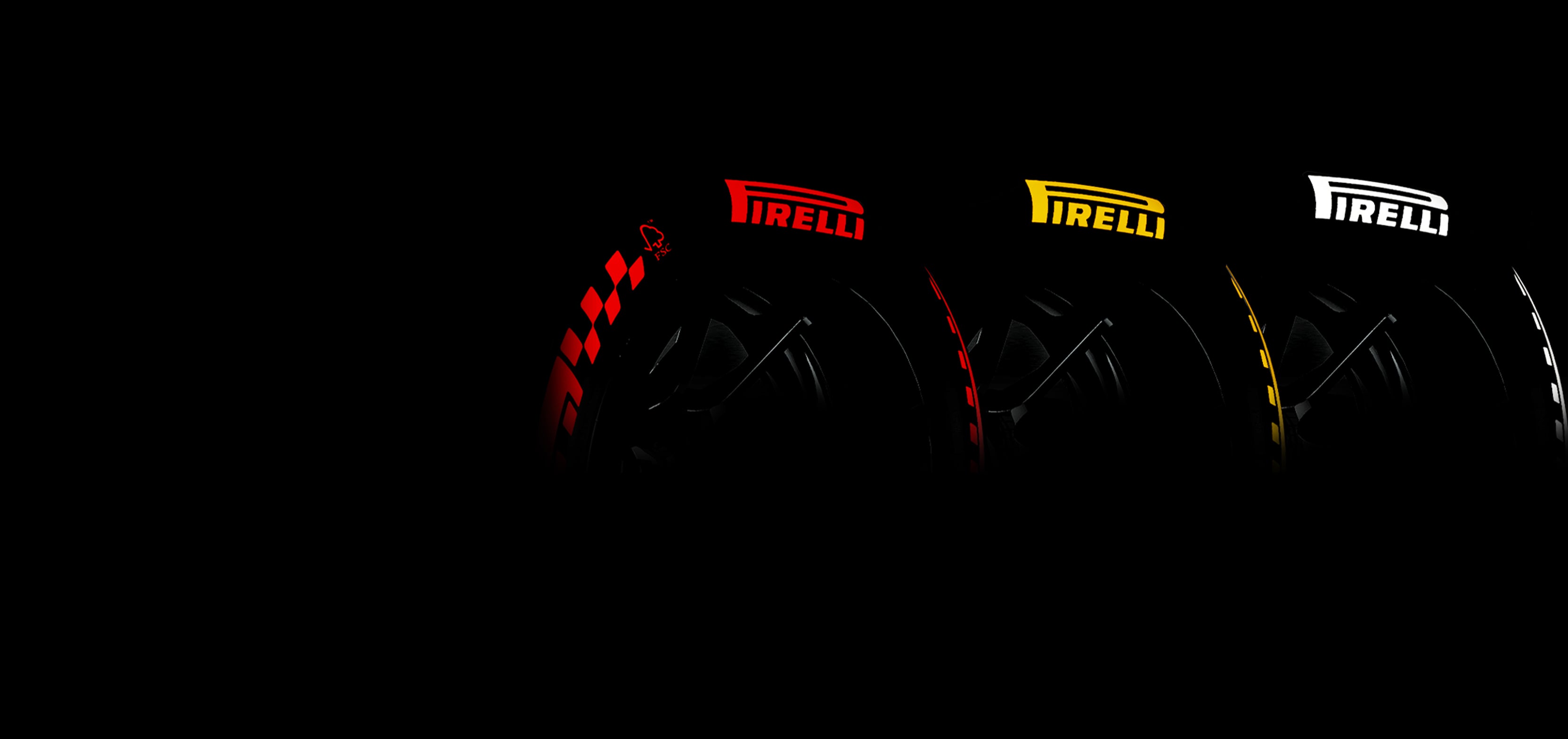 Three Pirelli tires displayed against a black background